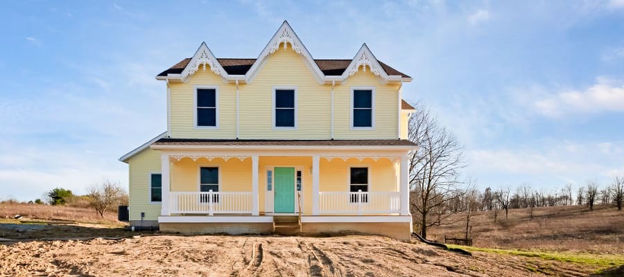 Customized Adams with yellow siding and teal blue door.