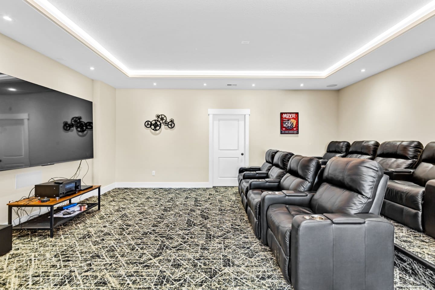 Theater room with leather seats and big screen tv.